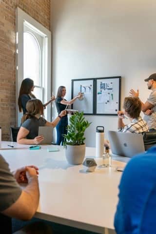 Product team collaborating around a planning board
